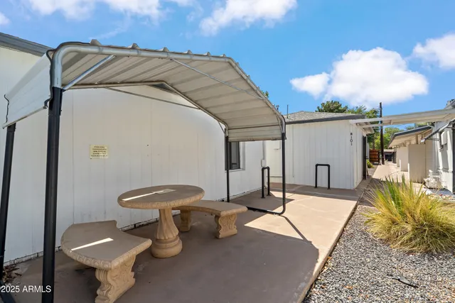 a view of a patio with table and chairs
