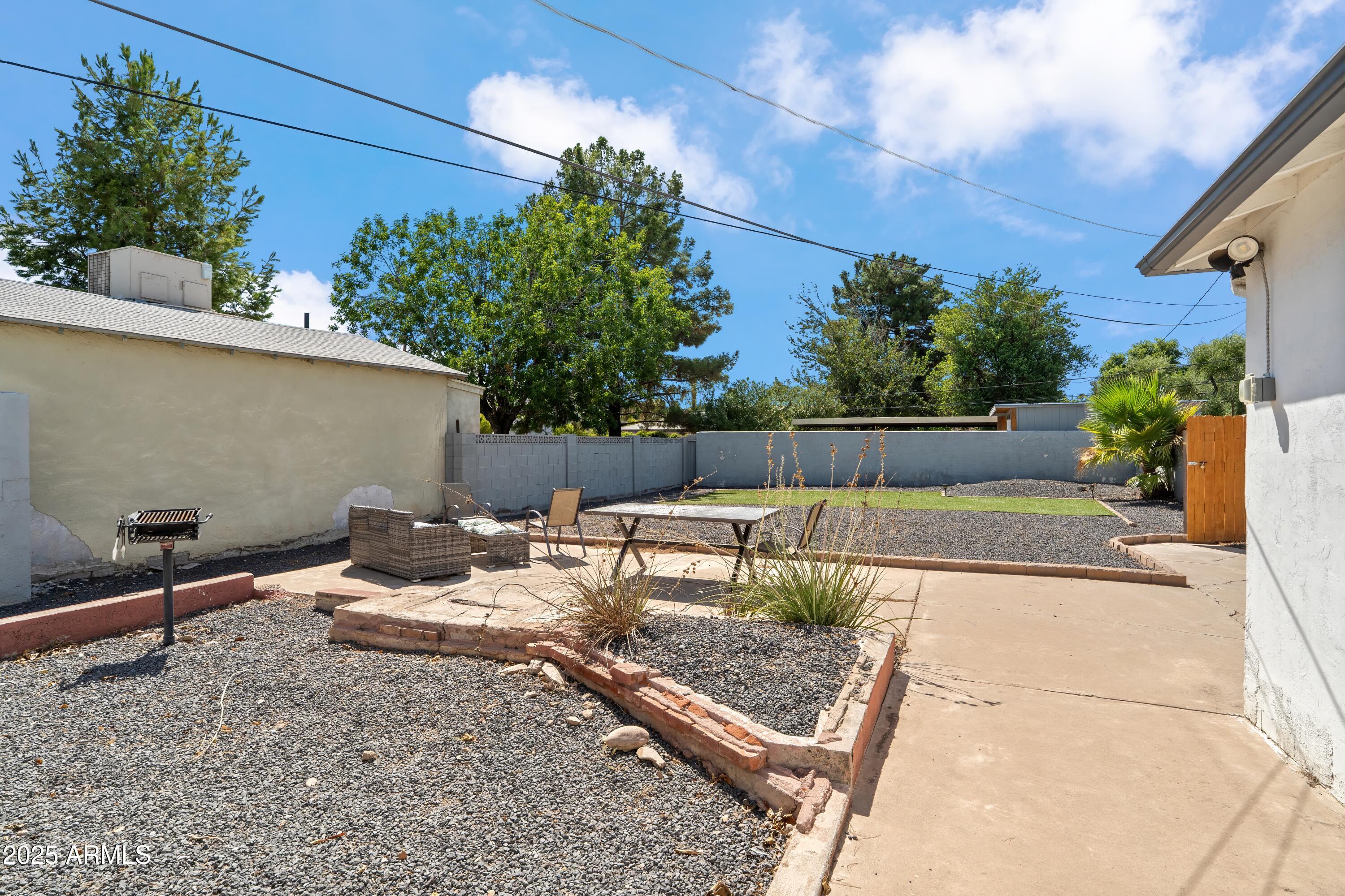 1218 South Farmer Avenue Tempe, AZ 85281 - Photo 27 of 47 a view of backyard with seating space and trees