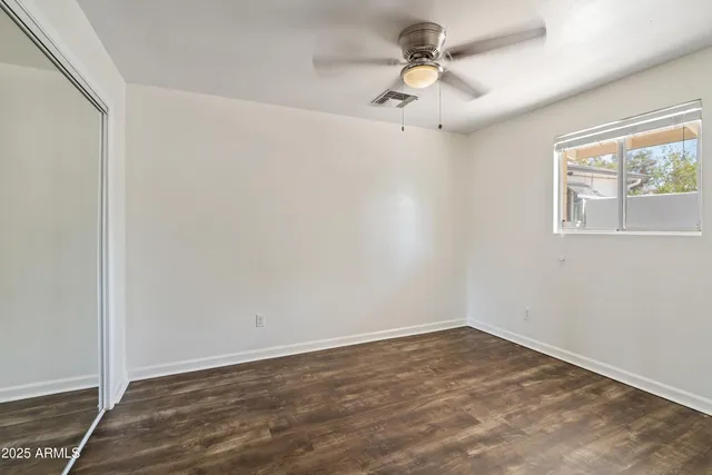a view of a room with wooden floor and a window