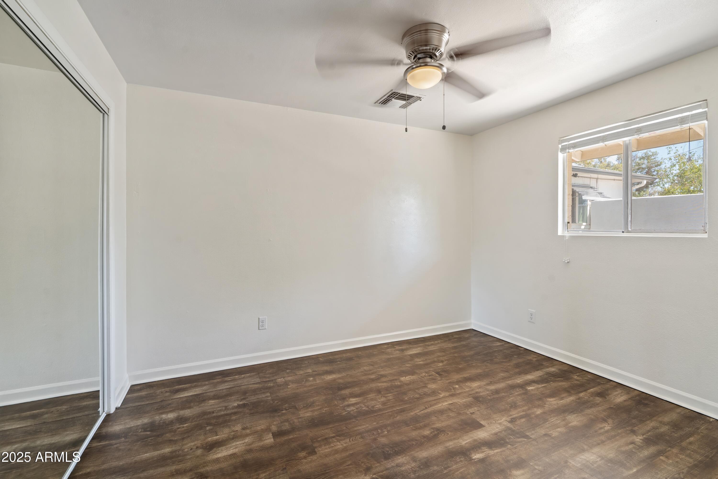 1218 South Farmer Avenue Tempe, AZ 85281 - Photo 35 of 47 an empty room with a window and a ceiling fan