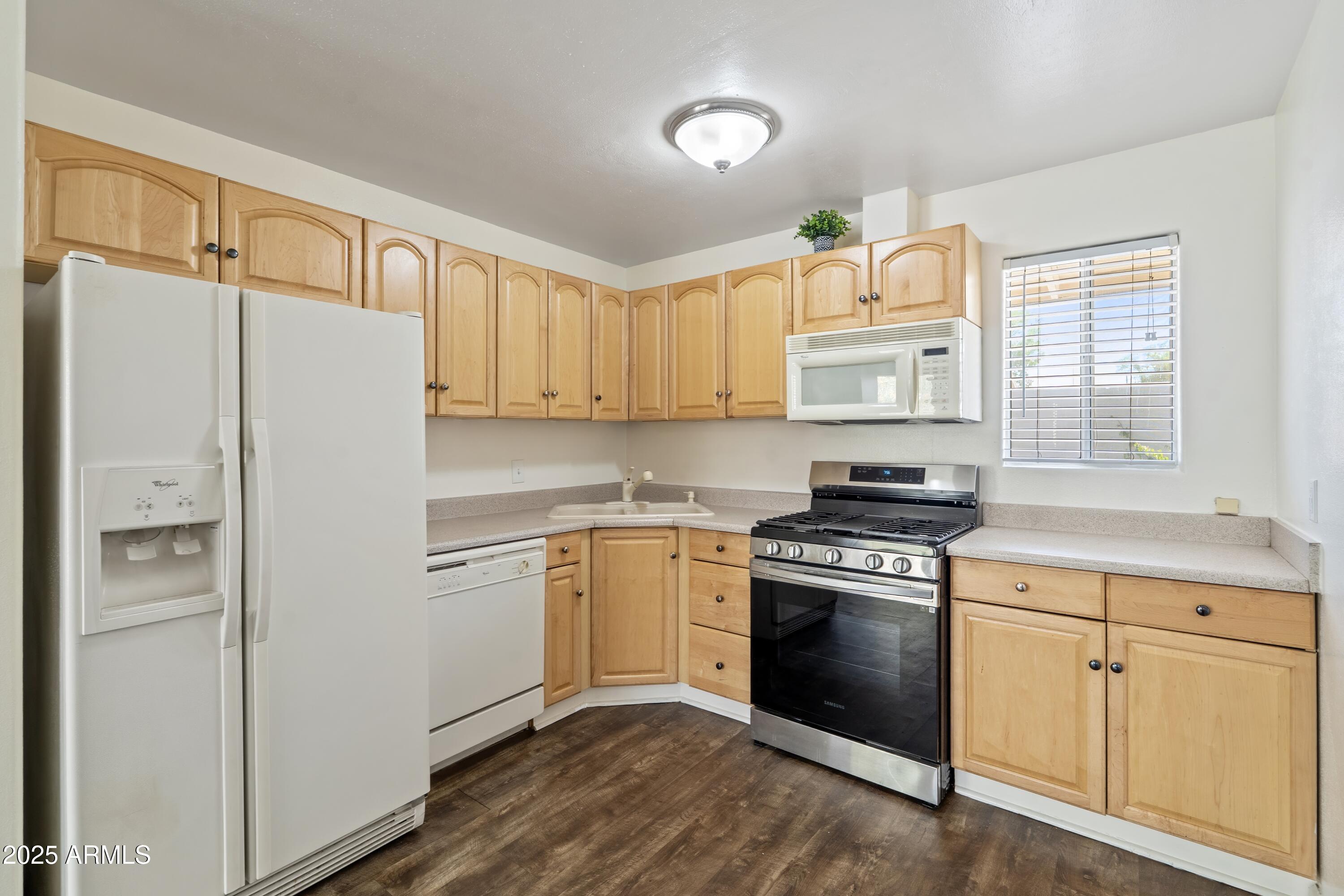 1218 South Farmer Avenue Tempe, AZ 85281 - Photo 38 of 47 a kitchen with white cabinets and white appliances