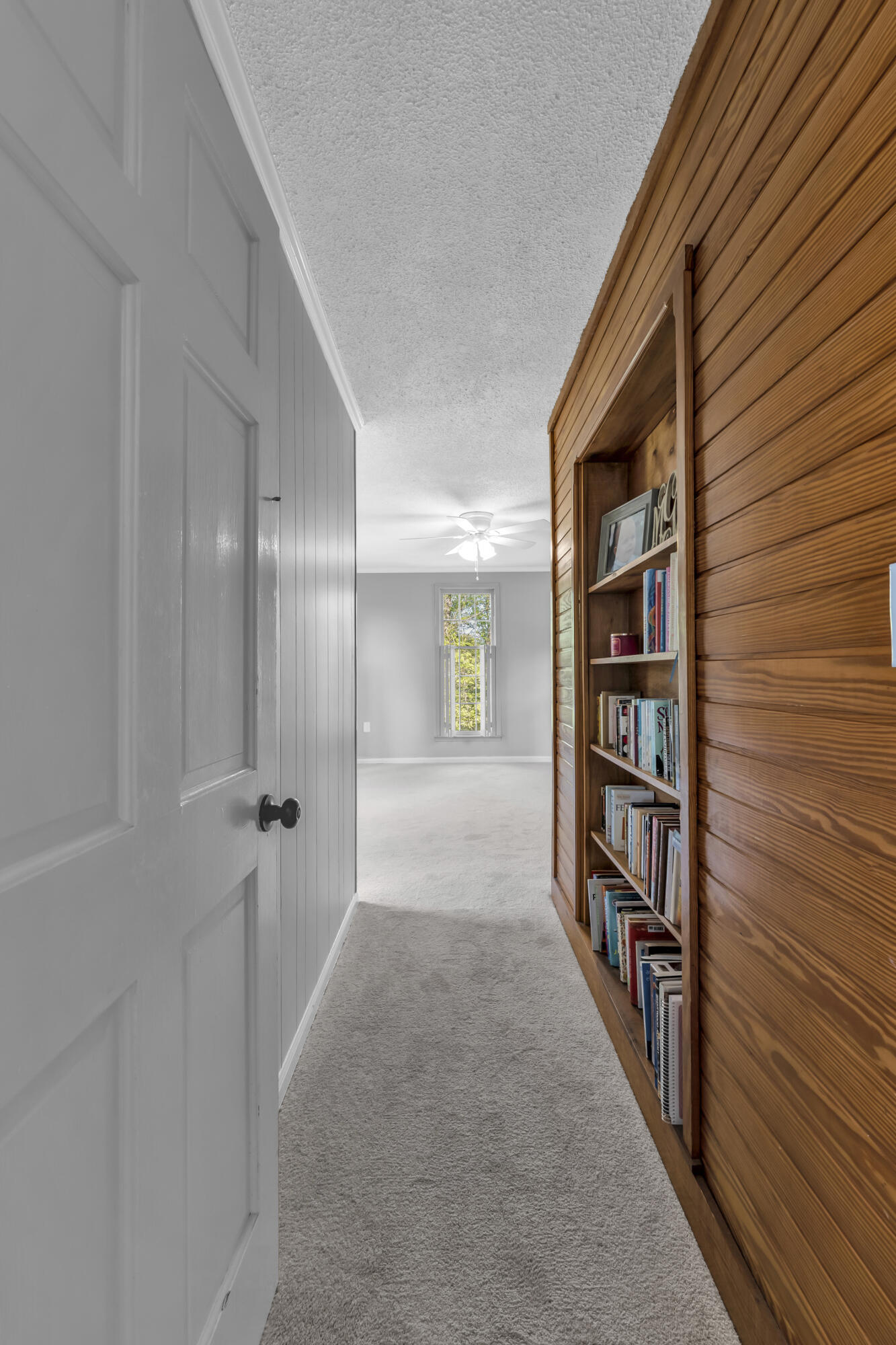 3159 Twin Pine Road Thomson, GA 30824 - Photo 22 of 36 Entrance to primary bedroom main level downstairs with wood bookcase detail