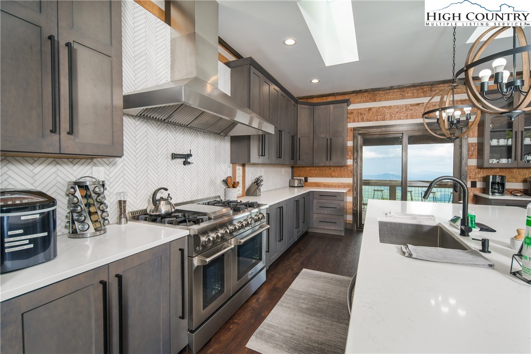 351 Broken Arrow Trail Boone, NC 28607 - Photo 13 of 48 a kitchen with stainless steel appliances a sink a stove and cabinets