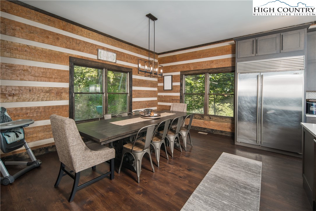351 Broken Arrow Trail Boone, NC 28607 - Photo 17 of 48 a dining room with furniture a chandelier and wooden floor