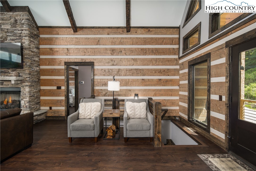 351 Broken Arrow Trail Boone, NC 28607 - Photo 19 of 48 a living room with furniture wooden floor and a fireplace