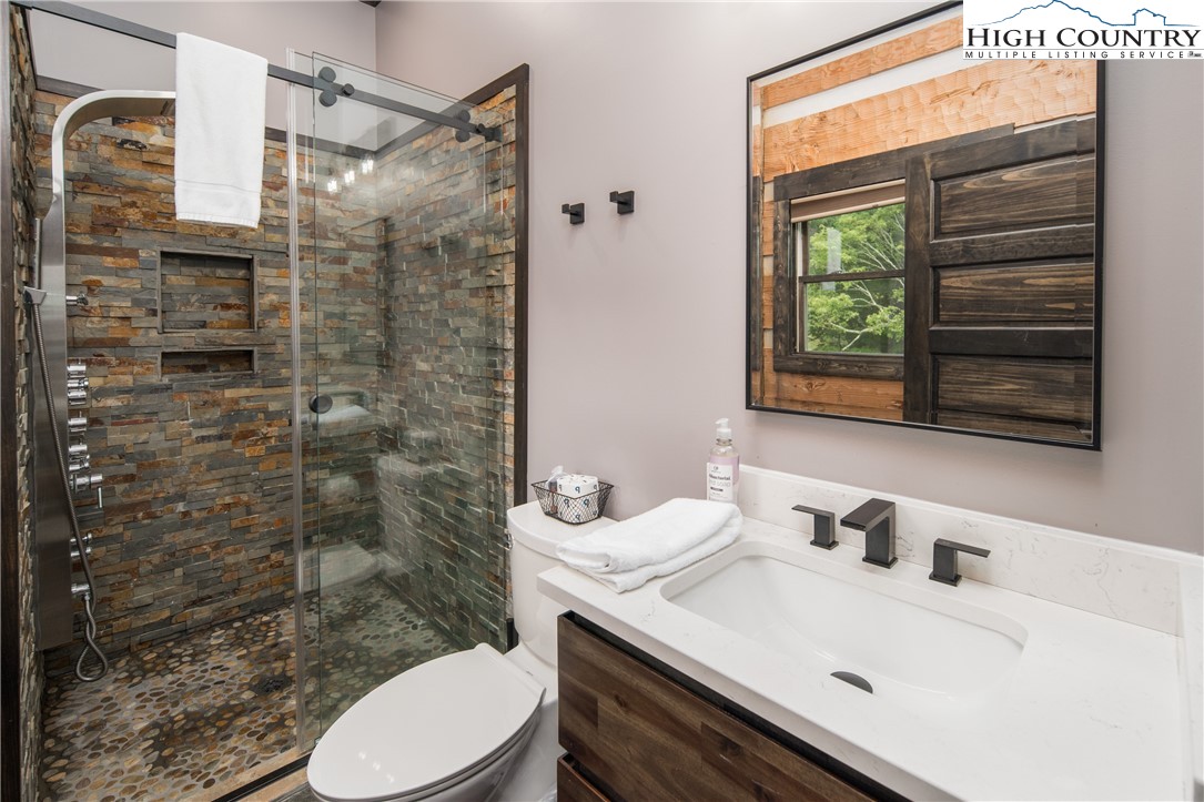 351 Broken Arrow Trail Boone, NC 28607 - Photo 24 of 48 a bathroom with a sink toilet and shower