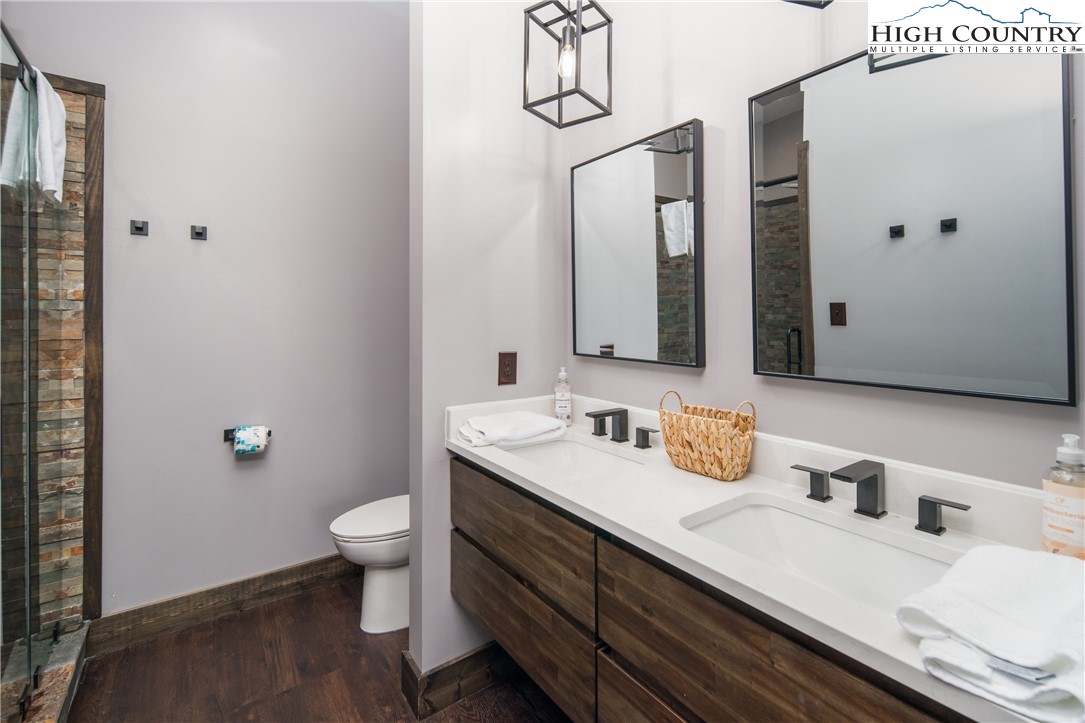351 Broken Arrow Trail Boone, NC 28607 - Photo 31 of 48 a bathroom with a double vanity sink toilet and mirror