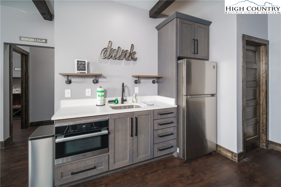 351 Broken Arrow Trail Boone, NC 28607 - Photo 41 of 48 a kitchen with stainless steel appliances a refrigerator and a stove top oven