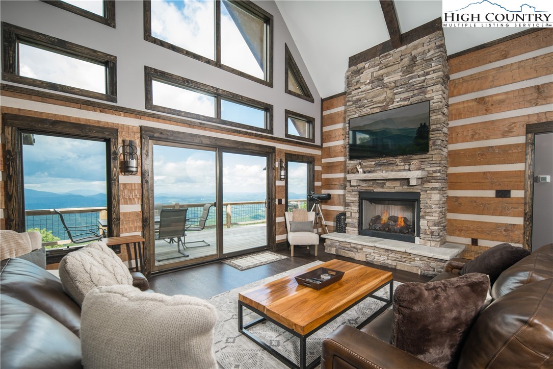 351 Broken Arrow Trail Boone, NC 28607 - Photo 9 of 48 a living room with furniture a flat screen tv and a fireplace