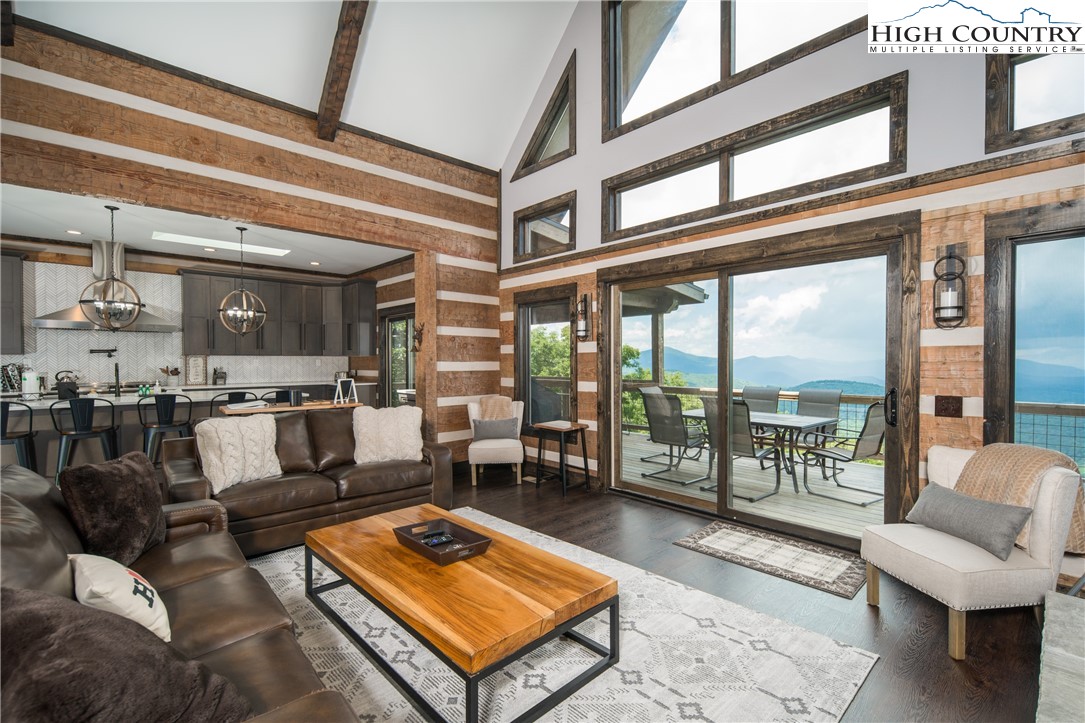 351 Broken Arrow Trail Boone, NC 28607 - Photo 10 of 48 a living room with furniture and a floor to ceiling window
