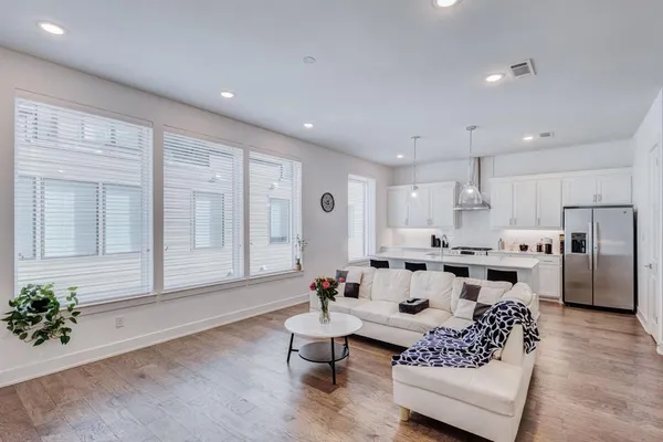 a living room with furniture white walls and a potted plant