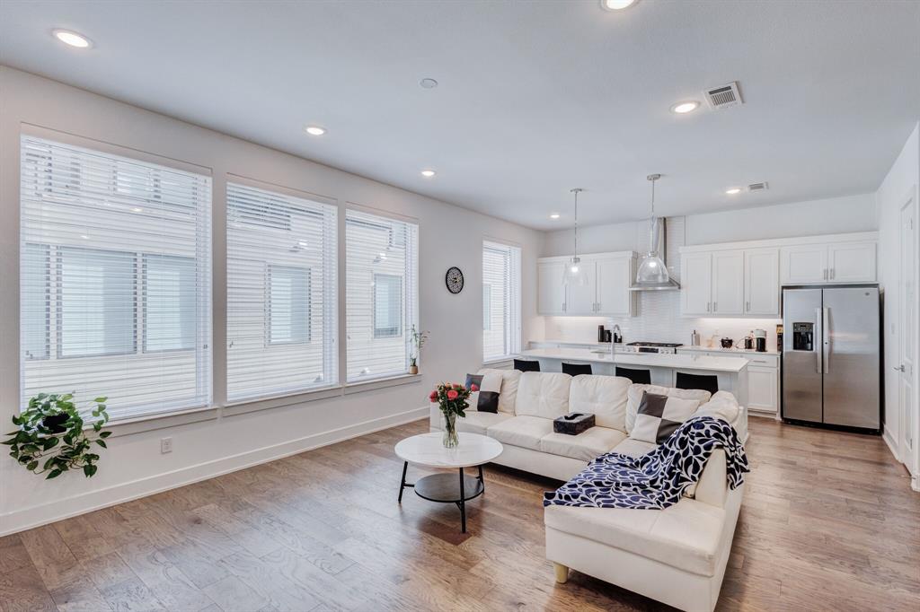 a living room with furniture white walls and a potted plant