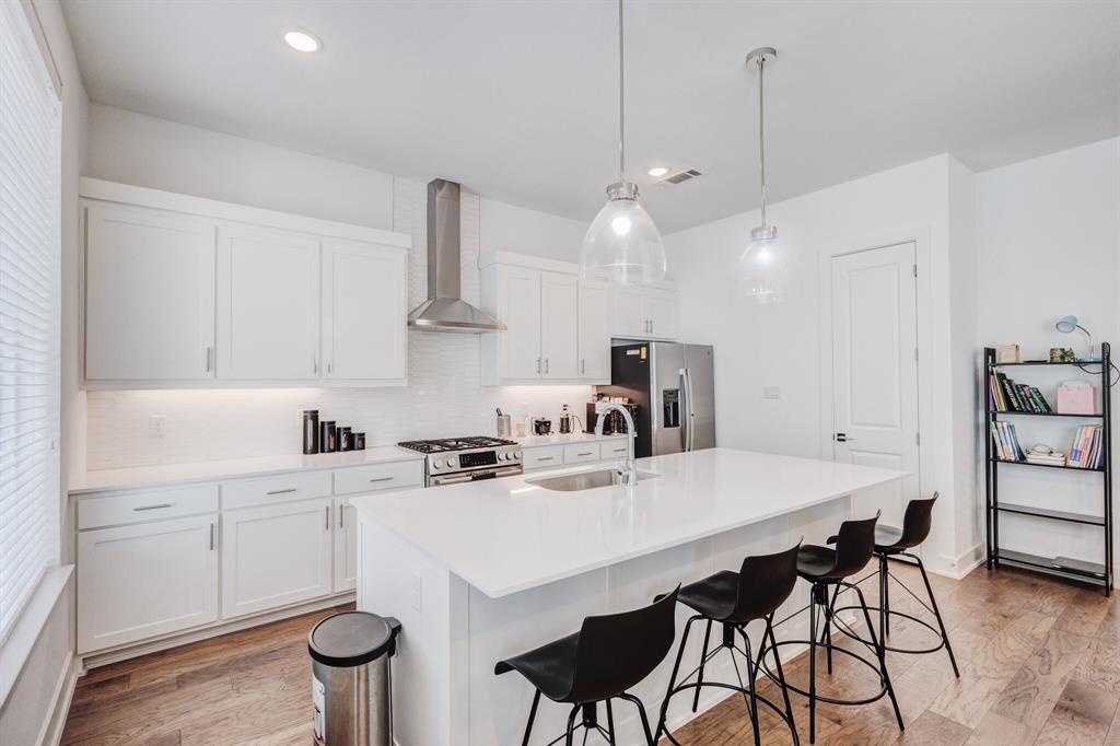 114 Chester Court Dallas, TX 75203 - Photo 13 of 31 a kitchen with a dining table chairs sink and cabinets