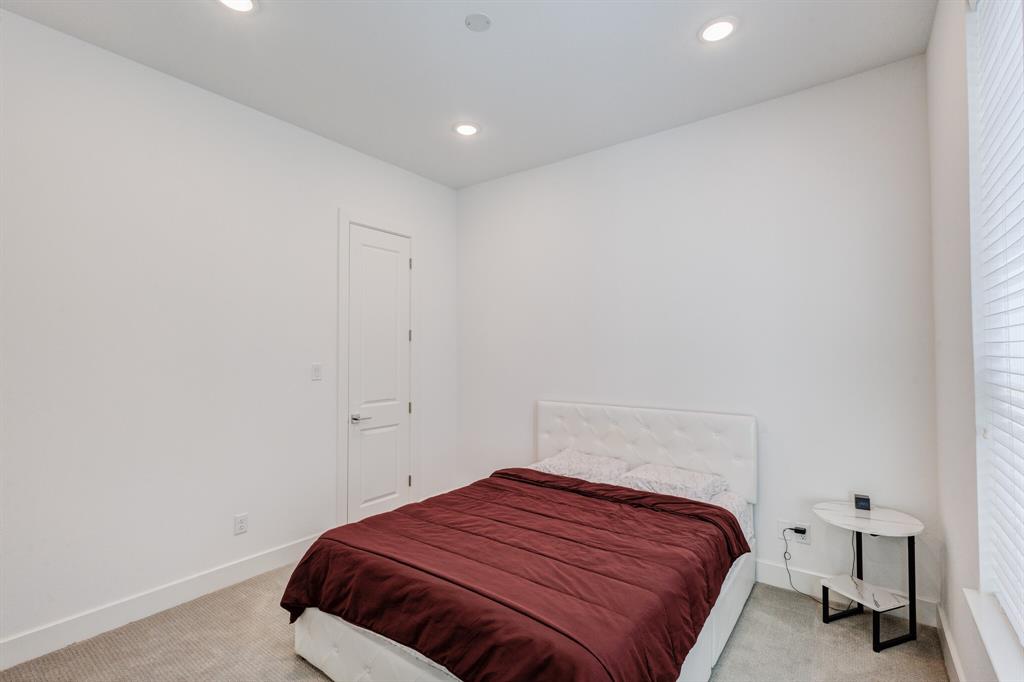 114 Chester Court Dallas, TX 75203 - Photo 15 of 31 a bedroom with a bed and a window