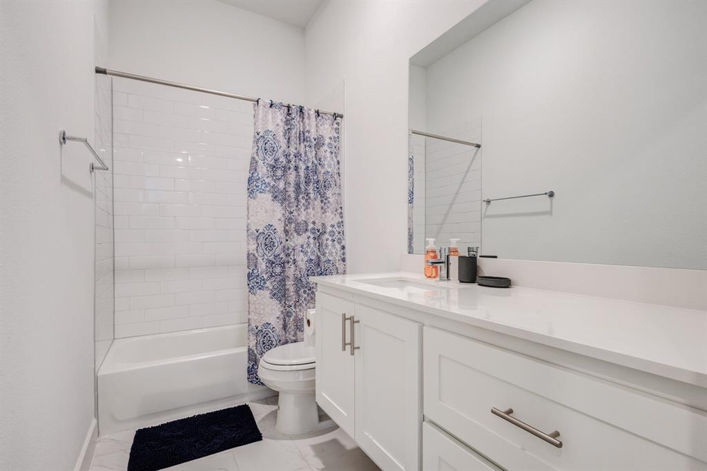 114 Chester Court Dallas, TX 75203 - Photo 2 of 31 a bathroom with a sink a toilet and a shower