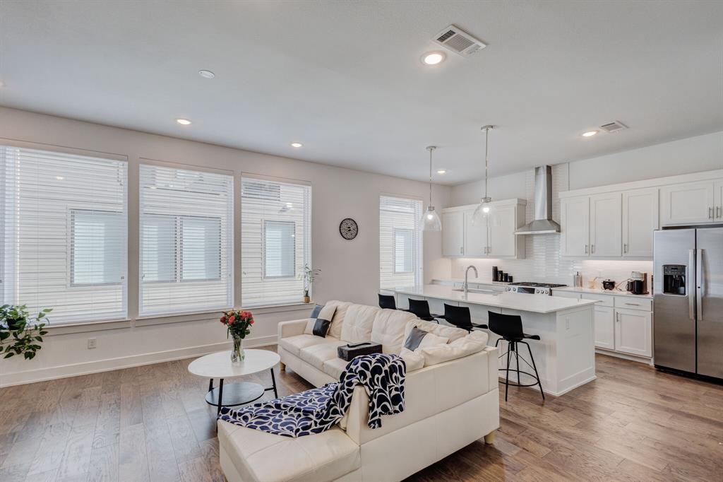 114 Chester Court Dallas, TX 75203 - Photo 8 of 31 a living room with furniture wooden floor and a table
