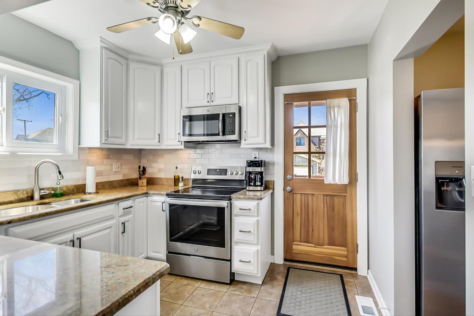 272 North Willow Road Elmhurst, IL 60126 - Photo 10 of 33 a kitchen with cabinets stainless steel appliances and a window