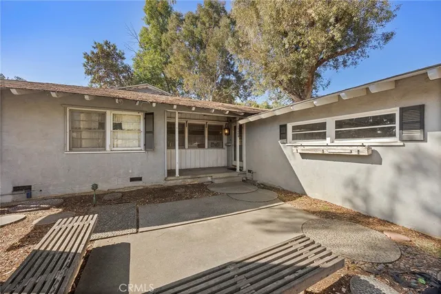 a view of empty room with wooden floor and fireplace
