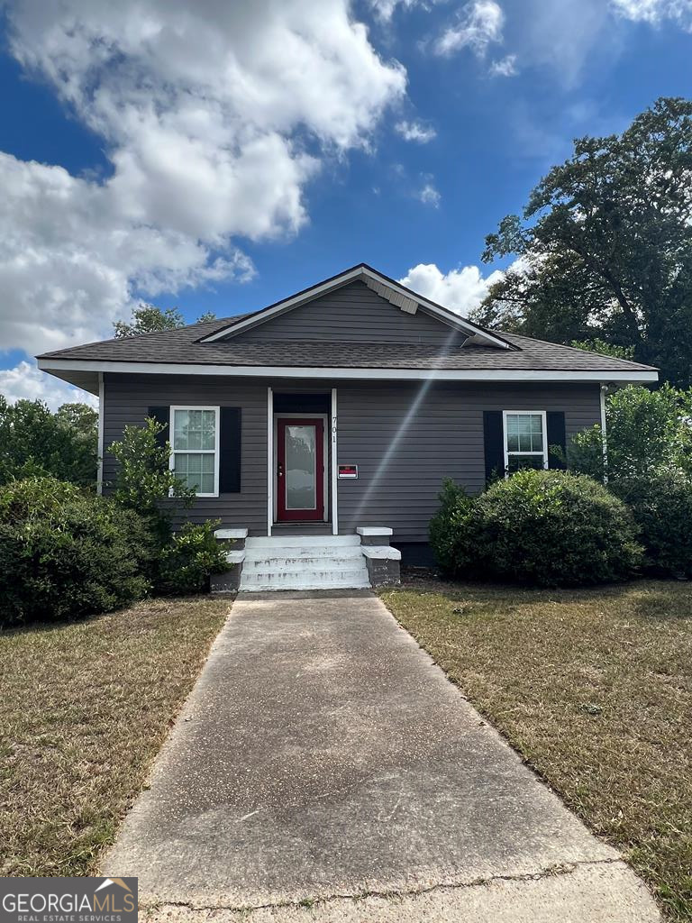 a front view of a house with garden