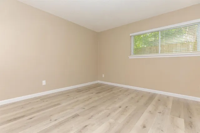 a bathroom with a granite countertop sink and mirror with bathtub