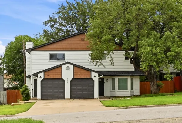 a front view of house with yard and garage