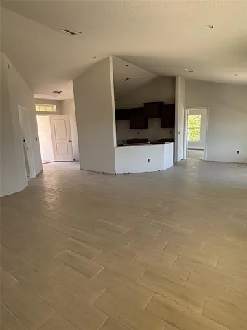 a kitchen with stainless steel appliances granite countertop a sink a stove and a refrigerator