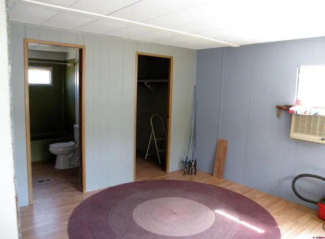 a bedroom with bed and a mirror