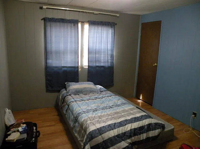 a bedroom with a bed and a closet