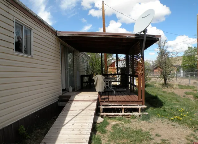 a couple of chairs sitting in backyard of house