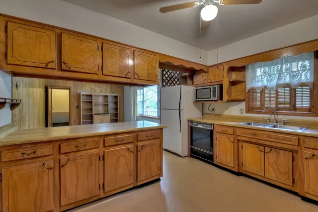 a kitchen with granite countertop cabinets stainless steel appliances and a sink