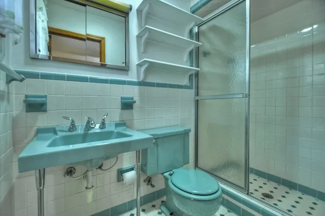 a bathroom with a sink a toilet and window