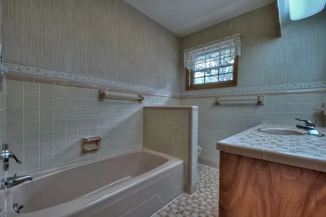 an aerial view of residential houses with outdoor space and trees