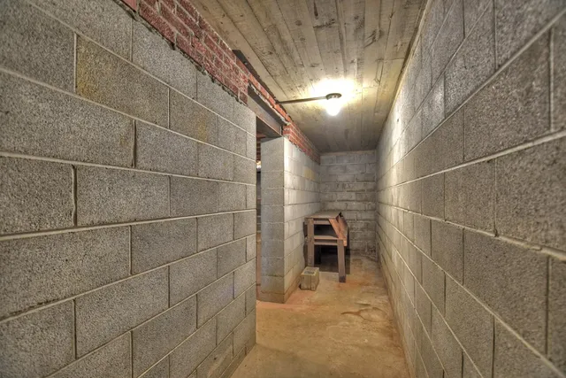 a front view of a house with a yard and potted plants