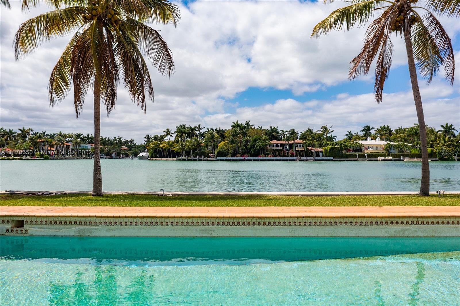 2220 North Bay Road Miami Beach, FL 33140 - Photo 4 of 9 a view of swimming pool with a yard and a large trees