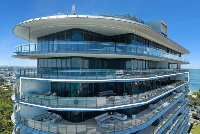 a view of a swimming pool with outdoor seating and plants