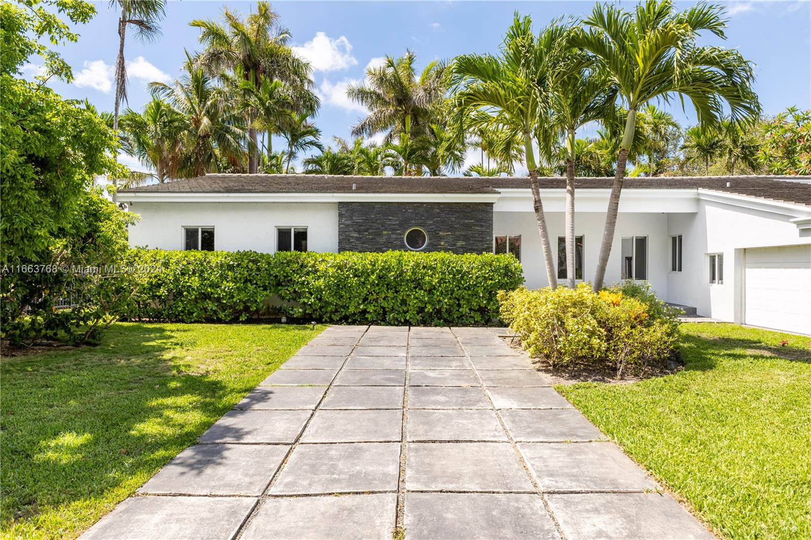 5785 Alton Road Miami Beach, FL 33140 - Photo 2 of 46 front view of a house with a yard