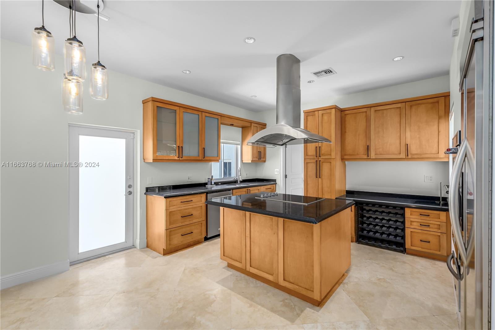 5785 Alton Road Miami Beach, FL 33140 - Photo 27 of 46 a kitchen with stainless steel appliances granite countertop a sink a stove and a refrigerator