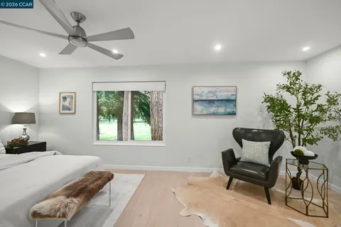 a bedroom with a bed and a chair