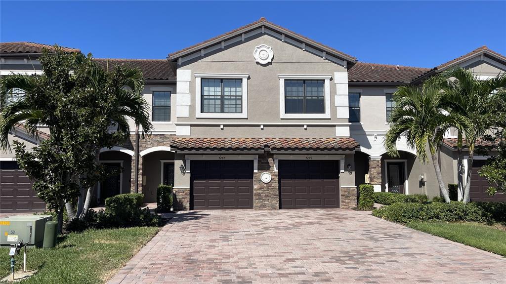7287 Ketch Place Bradenton, FL 34212 - Photo 1 of 29 a front view of a house with a garden
