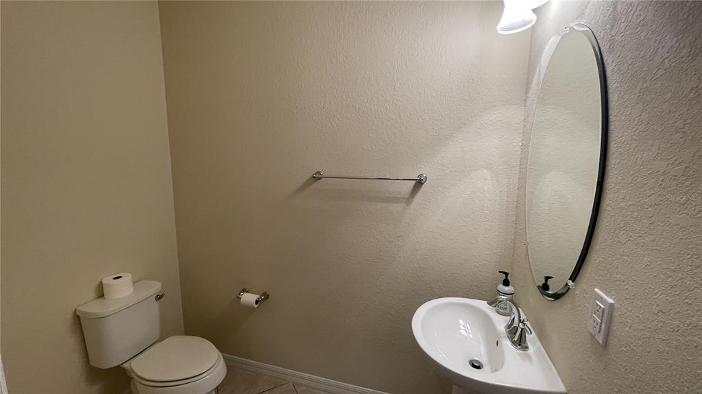 7287 Ketch Place Bradenton, FL 34212 - Photo 11 of 29 a bathroom with a toilet mirror and vanity