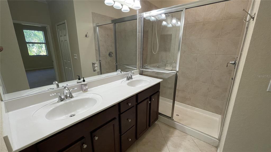 7287 Ketch Place Bradenton, FL 34212 - Photo 17 of 29 a bathroom with a sink double vanity and a mirror