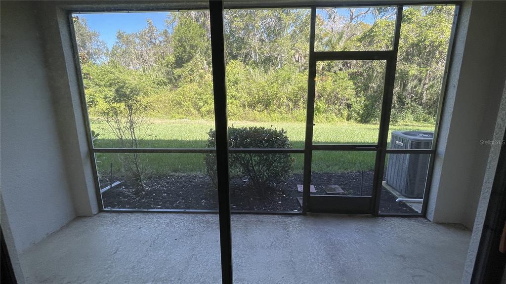 7287 Ketch Place Bradenton, FL 34212 - Photo 25 of 29 a view of a room with sliding glass door and porch