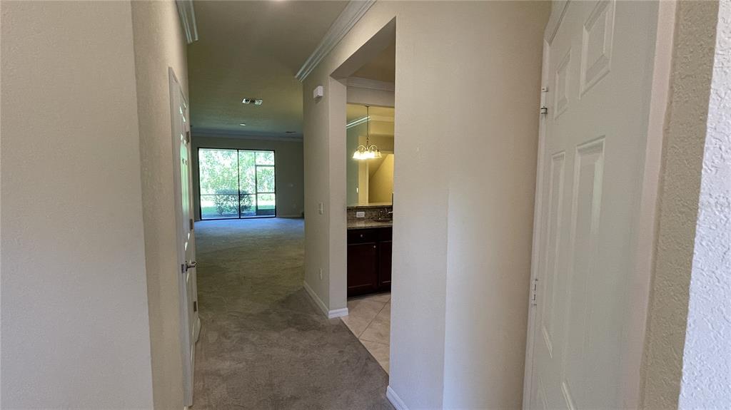 7287 Ketch Place Bradenton, FL 34212 - Photo 4 of 29 a view of a hallway with wooden shelves