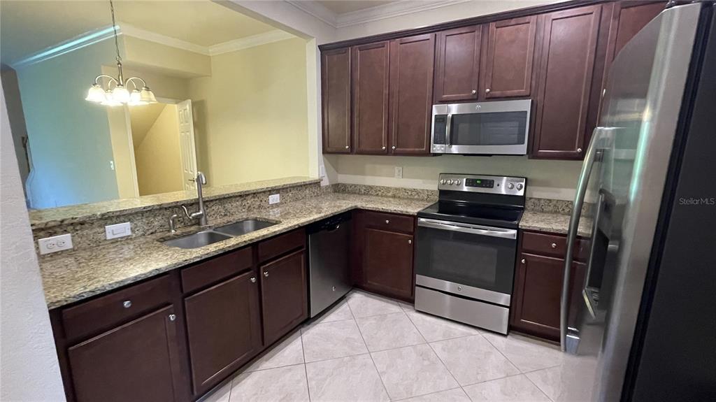 7287 Ketch Place Bradenton, FL 34212 - Photo 5 of 29 a kitchen with a sink stove and microwave