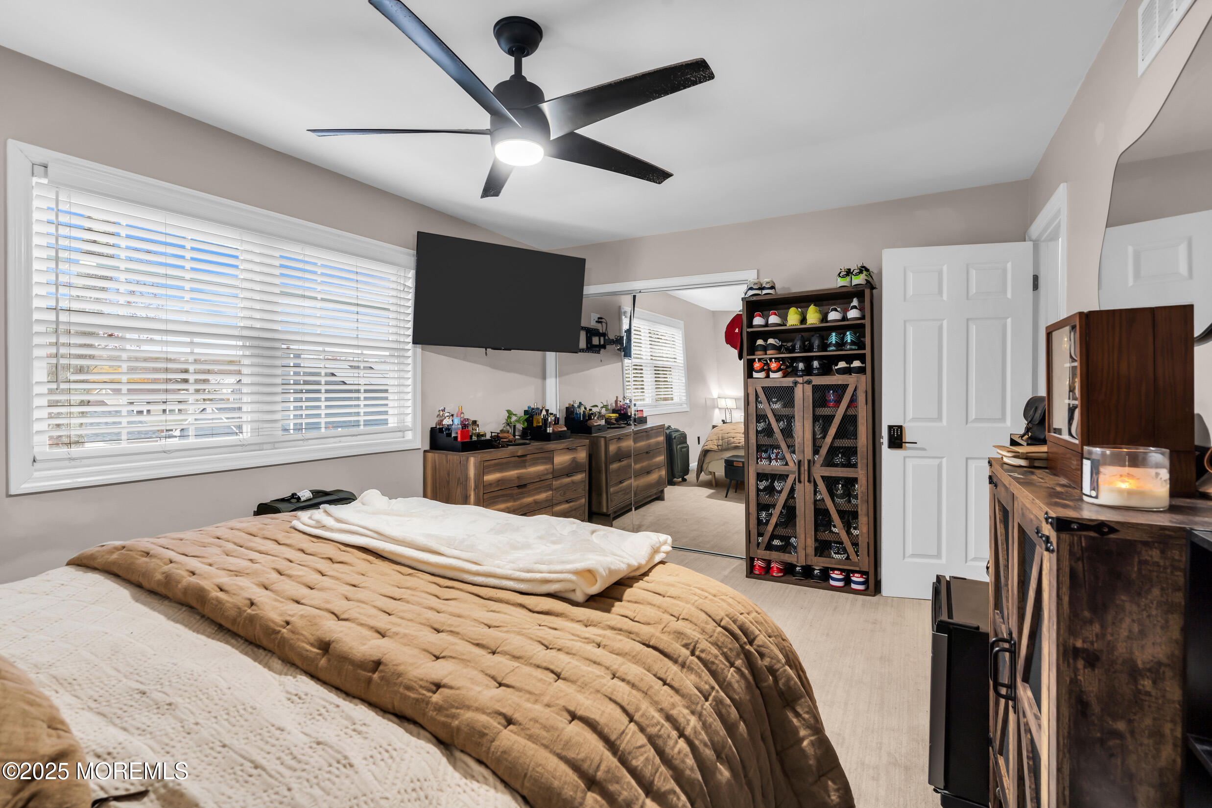 5 Sloop Court Barnegat, NJ 08005 - Photo 19 of 29 a bedroom with a bed a flat screen tv and a large window