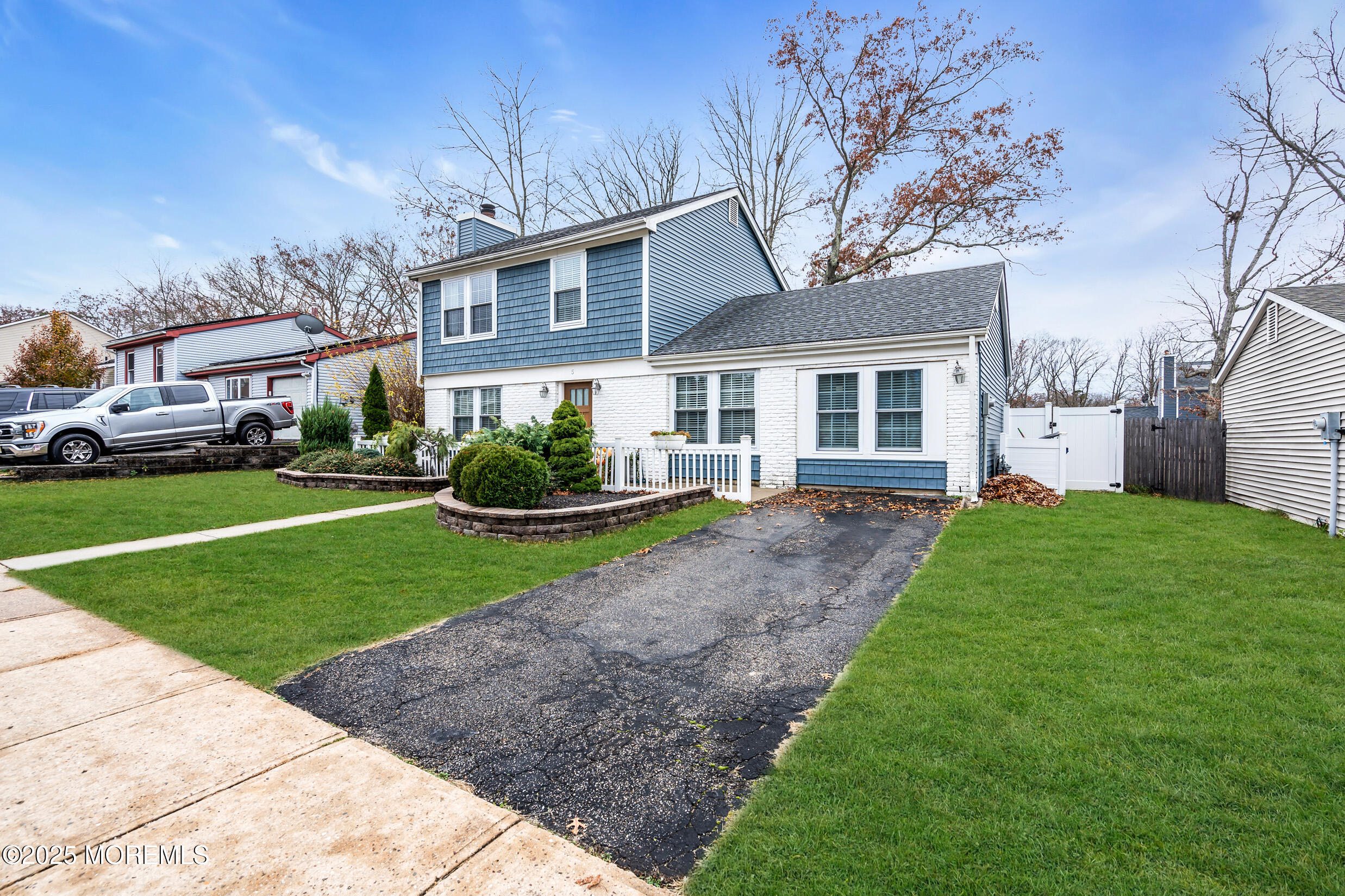 5 Sloop Court Barnegat, NJ 08005 - Photo 3 of 29 a front view of a house with a garden and trees
