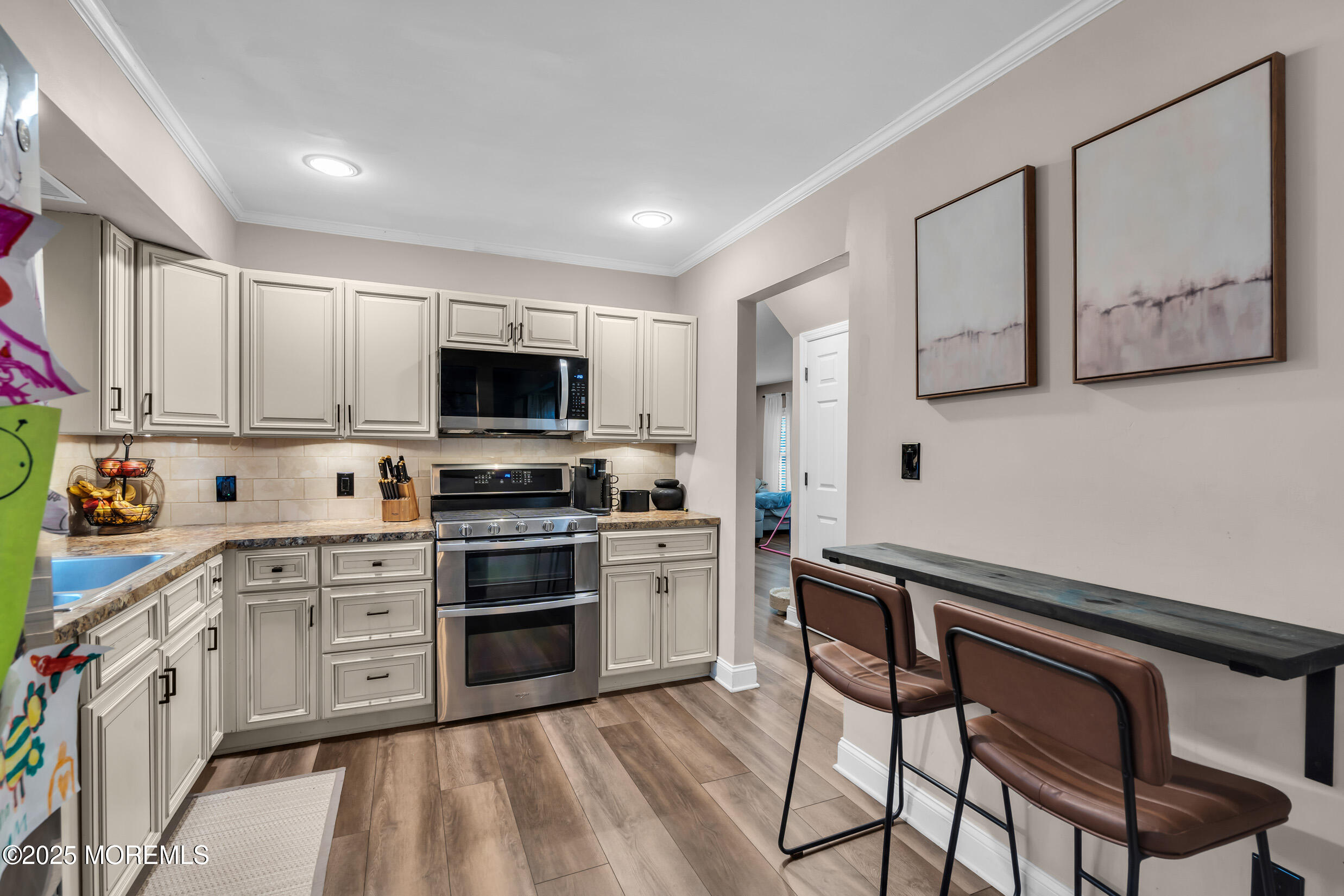 5 Sloop Court Barnegat, NJ 08005 - Photo 7 of 29 a kitchen with stainless steel appliances a stove top oven a sink dishwasher and a refrigerator with wooden floor