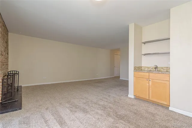 a bathroom with a granite countertop sink a mirror and a shower