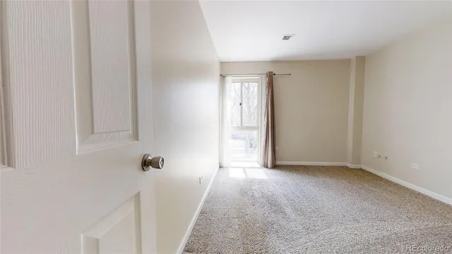 an empty room with windows and closet