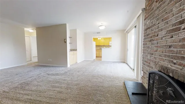 a view of an empty room and fire place